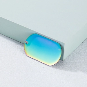 Rainbow titanium steel dog tag pendant with rounded rectangular shape on minimalist grey block