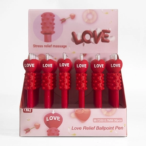 Detail view of stress relief massage pens with heart-shaped tops in a pink display box