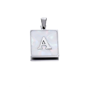 Detailed close-up of a silver square pendant with white shell inlay and metal letter A