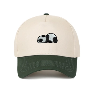 Detail of panda embroidery on two-tone cream and dark green trucker baseball cap