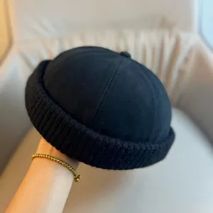 Detailed view of black Miki Hat featuring a ribbed knit cuff and minimalist crown