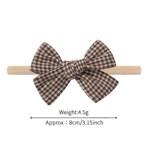 Elastic nylon baby headband with a brown checkered bow detail on a white background