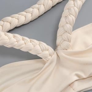 Detail of elegant braided shoulder strap on a silk off-shoulder fishtail evening dress
