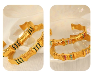 Detailed macro view of C-shaped bamboo texture gold bracelet with colorful rhinestones
