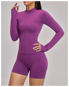 Detail of purple zip-up yoga jacket with stand collar and moisture-wicking fabric
