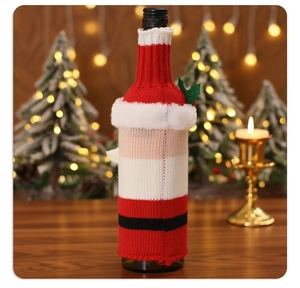 Detailed view of knitted Christmas wine bottle cover with soft white plush trim decor