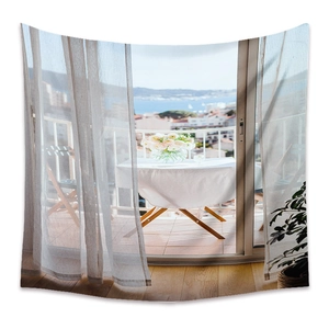 Detail of bohemian balcony seaside tapestry with floral table and ocean view