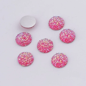 Detailed view of 14mm round pink resin druzy cabochons with sparkling textured surface