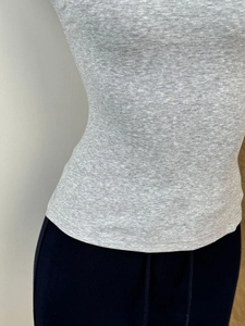 Detailed texture of light grey ribbed knit fabric on a slim fit cropped top
