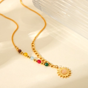 Detail of 18K gold sun pendant with pink bead and colorful gemstone beaded chain