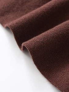 Macro detail of high-quality brown knitted fabric with soft texture and refined stitching