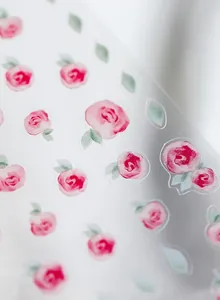 Macro shot of Japanese style pro matte pink rose nail stickers with delicate green leaves