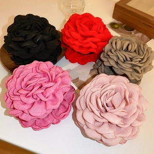 Macro view of multi-layered fabric rose hair claws in various elegant colors for women