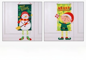 Detail of Merry Christmas hanging banners featuring snowman and elf on white door