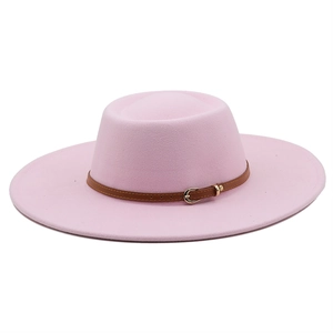 Detail of pink wool fedora hat featuring a brown leather strap and metal buckle