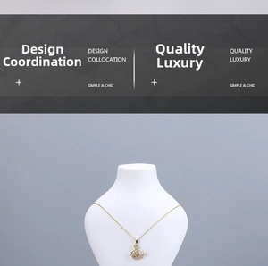 Detailed view of a gold swan pendant necklace featuring brilliant white rhinestones