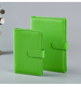 Detail view of two green Macaron A5 and A6 PU leather notebooks with snap button closures