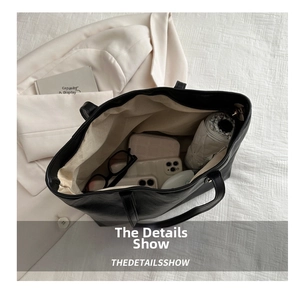 Spacious interior of large black PU tote bag showing capacity for daily essentials