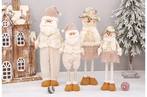 Detail of plush Christmas Santa and Snowman dolls in cream and champagne gold tones