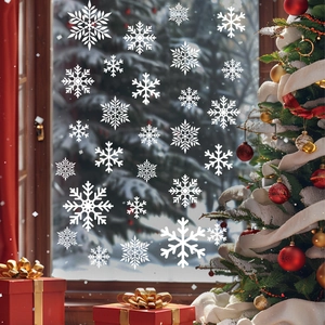 Macro detail of white snowflake window decals on glass with festive Christmas background
