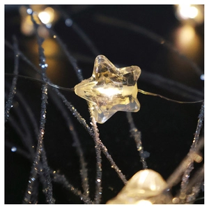 Macro shot of star-shaped warm white LED string lights with copper wire for Christmas decor