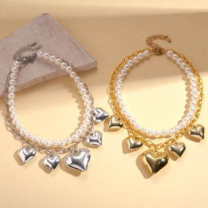 Two-layer faux pearl and metal chain necklace with heart pendants in gold and silver