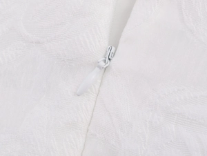 Detail of elegant white jacquard floral fabric texture and seamless invisible zipper
