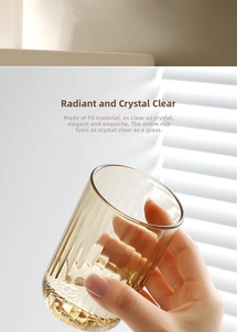 Champagne-colored ribbed PS material tumbler held in hand with soft natural lighting
