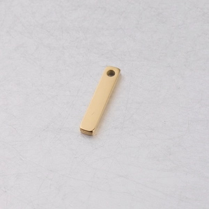 Polished golden stainless steel rectangular charm with single hole on metallic surface
