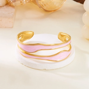 Detail of pink enamel wave bangle with gold-plated stainless steel double-layered frame