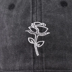 Washed black denim baseball cap with detailed white rose flower embroidery for unisex wear
