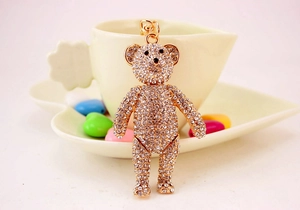 Detail of golden crystal bear keychain with shiny rhinestones and elegant gold-tone metal clasp