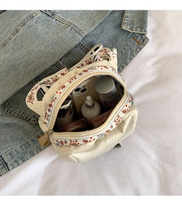 Detail view of large-capacity nylon crossbody bag with interior storage for daily items