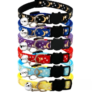 Detail of colorful pet collars with gold moon star prints and cat safety buckles