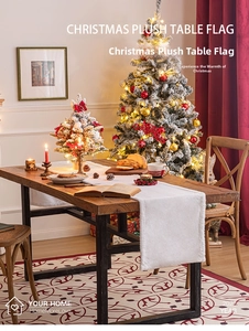 Plush white Christmas table runner on a wooden dining table with festive decorations