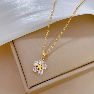 Elegant gold star flower necklace with sparkling zircons on premium silk backdrop