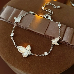 Detail view of silver butterfly bracelet with zircon and mother of pearl on jewelry box