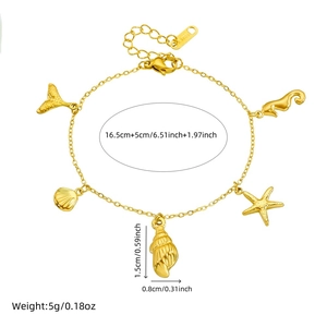 Gold ocean charms bracelet with starfish shell mermaid tail on white background