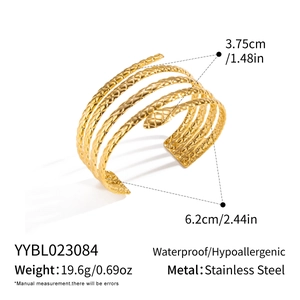 Macro view of gold snake coil bracelet detail with stainless steel texture and dimensions