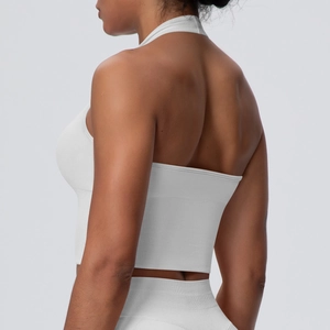 Close-up of white halter sports bra with vertical ribbed texture and seamless knit details