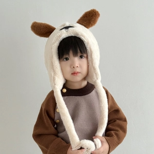 Detail of plush cartoon puppy hat with warm earflaps and soft fleece material for winter