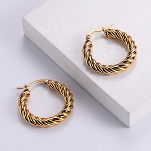 Classic golden twisted hoop earrings for women with elegant minimalist round design