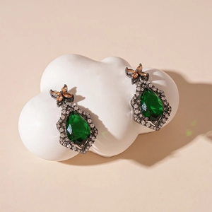 Vintage pear-cut emerald earrings with butterfly detail and black gold finish
