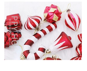 Close-up of red and white Christmas ornaments including candy canes and bells