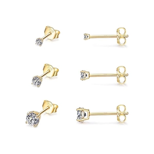 Macro shot of three pairs of gold S925 sterling silver stud earrings with 925 hallmarks
