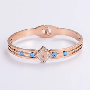 Detail view of rose gold evil eye bracelet with blue stones and sparkling rhinestones