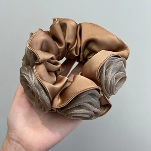 Close-up of a brown double-layered satin and organza rose-shaped hair scrunchie