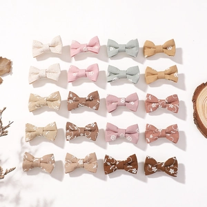 20-piece set of handmade cotton bow hair clips in solid colors and floral patterns