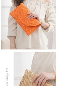 Detail of handwoven straw clutch bags featuring semi-circular textures in orange and natural beige