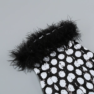 Detail of luxury crop top featuring ostrich feather trim and black white sequin polka dots